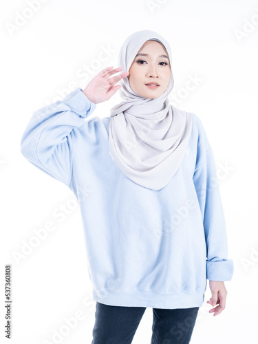 Portrait of a beautiful Muslim female model wearing modern and stylish casualwear with hijab isolated white studio background. Modern hijab fashion and beauty concept