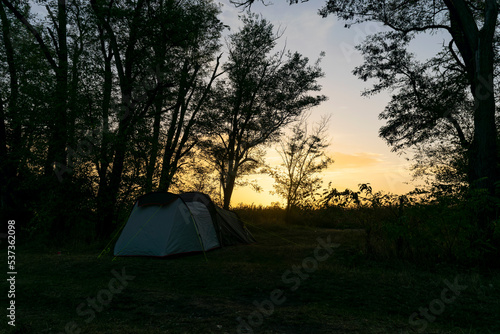 Camping and tent in the forest, at dawn.