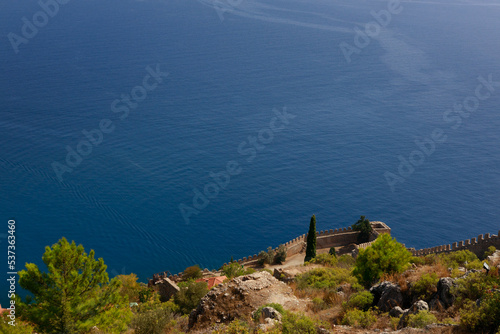 Wallpaper Mural the old wall of the ancient castle is visible against the blue sea.view from above. High quality photo Torontodigital.ca