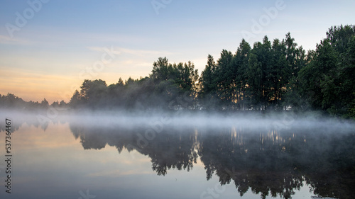 Fototapeta Naklejka Na Ścianę i Meble -  Fog in the early morning. Dawn by the river.