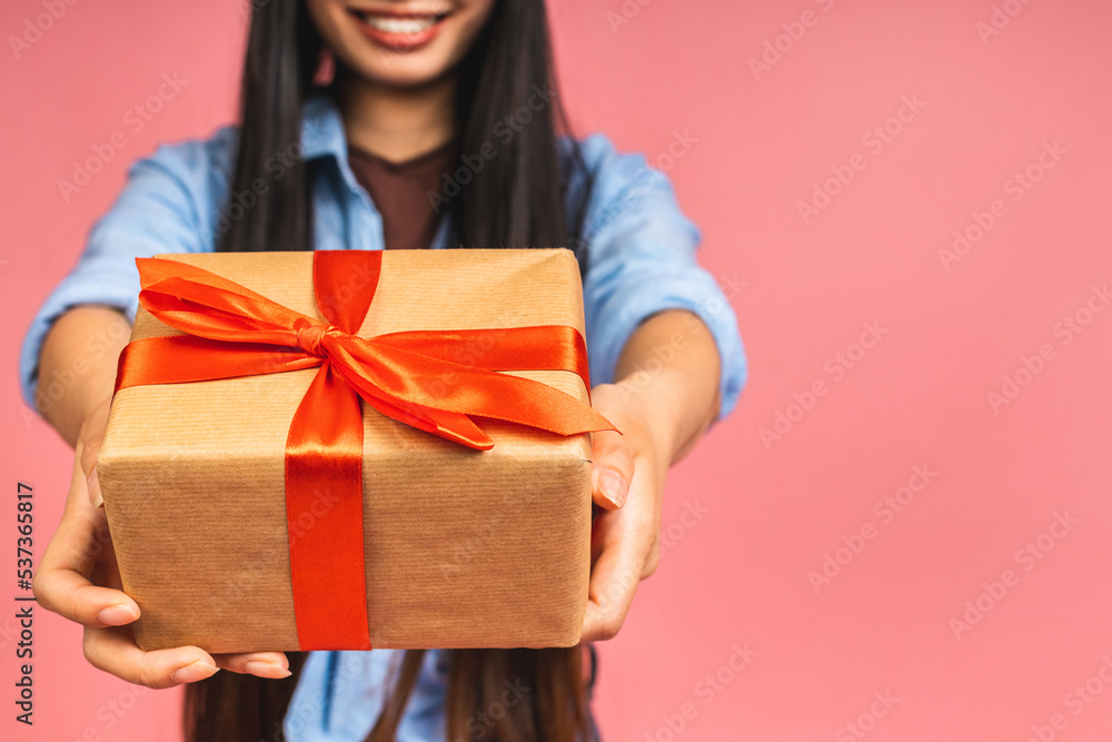 Happy beautiful asian woman holding gift box isolated on pink background. Teenage girls in love, Receiving gifts from lovers. New Year, Christmas and Valentines Day concept Happy beautiful asian woman holding gift box isolated on pink background. Teenage girls in love, Receiving gifts from lovers. New Year, Christmas and Valentines Day concept