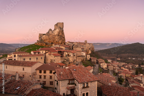 Panoramic landscape of the medieval village of Frías with old stone buildings and castle in the tophill at sunset, Burgos, Castile and Leon, Spain