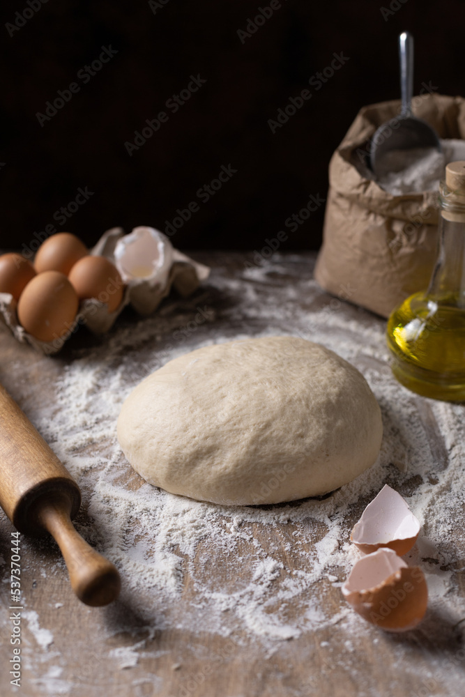 Wheat dough for bread cooking or pastry at table. Homemade bread making on wooden tabletop concept Wheat dough for bread cooking or pastry at table. Homemade bread making on wooden tabletop concept