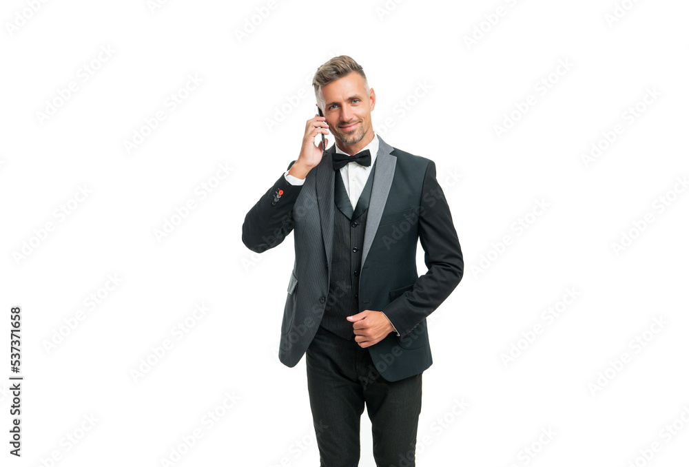 smiling positive businessman in tuxedo speak on phone isolated on white background smiling positive businessman in tuxedo speak on phone isolated on white background