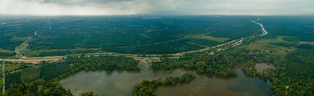 Panoramic aerial drone view of greenery scenery with a lake at Jasin, Melaka, Malaysia