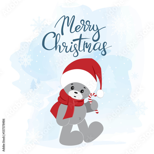 A teddy bear in a Santa Claus hat. Christmas greeting card. © Elena