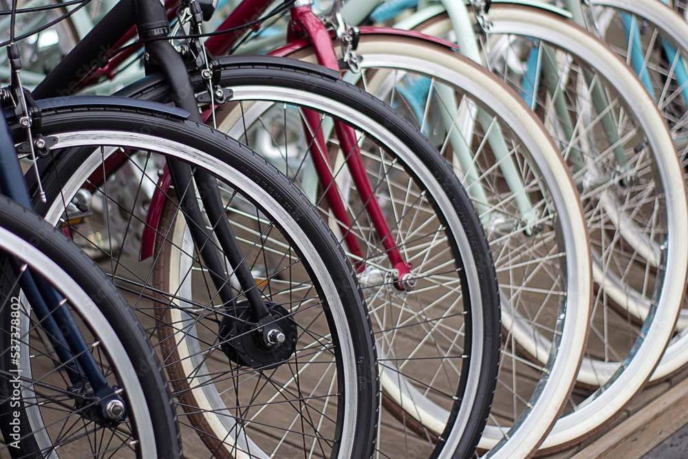 Front wheels of several bicycles close-up