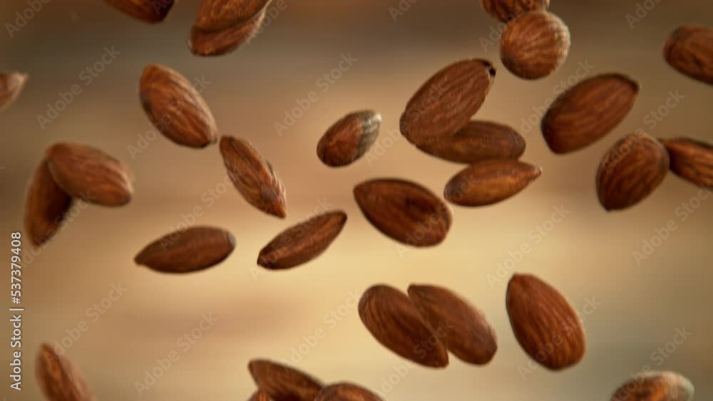 Falling of almonds, close-up, macro shot. Filmed on high speed cinematic camera at 1000 fps. Falling of almonds, close-up, macro shot. Filmed on high speed cinematic camera at 1000 fps.