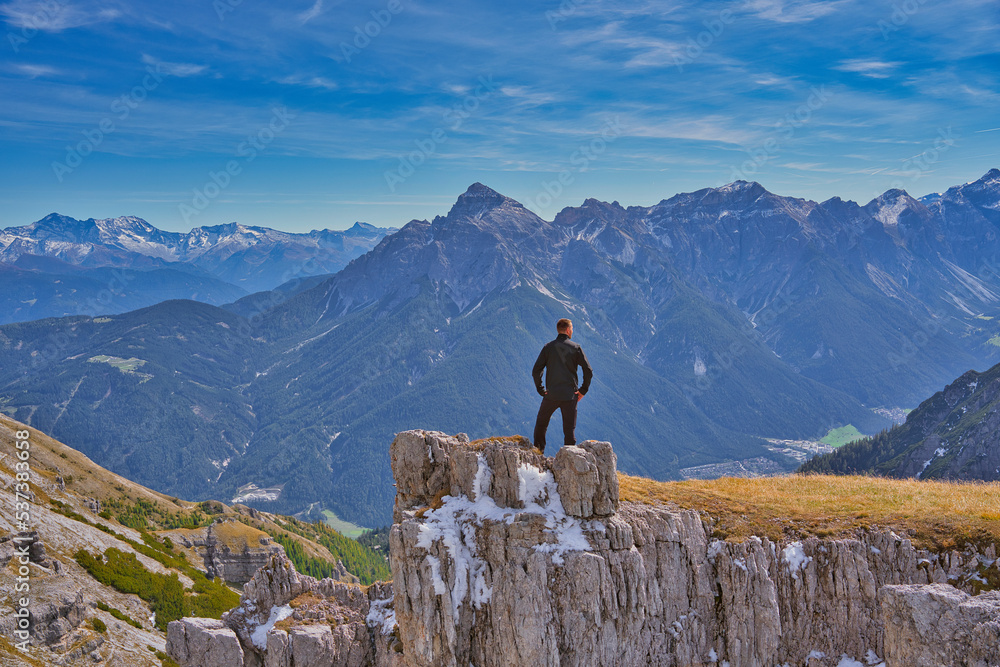 a hiker in front of the alps in Tyrol, Austria
