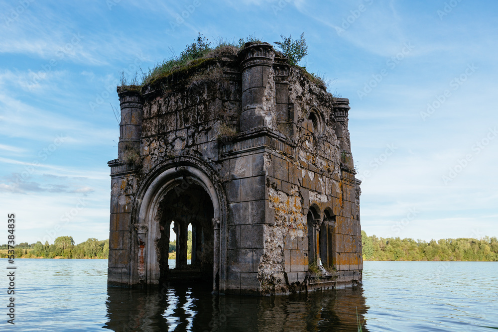 Old flooded ruined abandoned church. Ancient ruins on water Old flooded ruined abandoned church. Ancient ruins on water