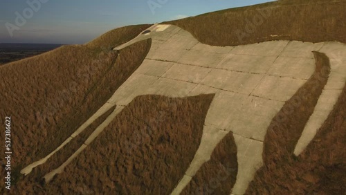 Flying away from the Westbury White Horse.  A hill figure in the UK. Evening. photo