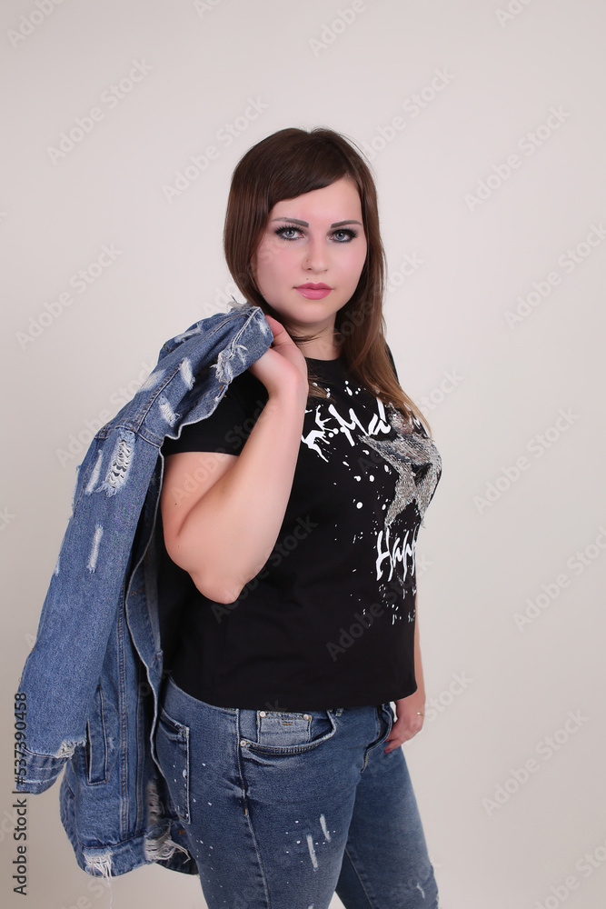 beautiful fashionable young plump fat big oversize girl model on the studio with piercings in a black t-shirt and jeans beautiful fashionable young plump fat big oversize girl model on the studio with piercings in a black t-shirt and jeans