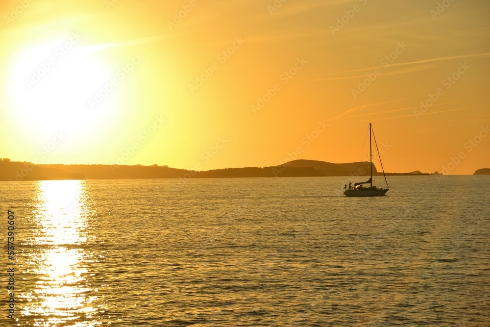sailing boat at sunset on ibiza