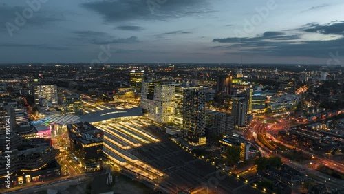 4k aerial time lapse of illuminated Utrecht central train station during rush hour with trains arriving and departing photo
