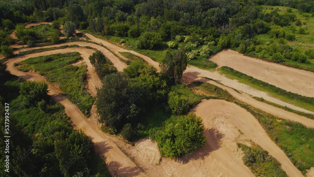 Aerial above view of a rural landscape with a curvy dirt road like a labyrinth running through it near Warsaw, Poland. High quality photo
