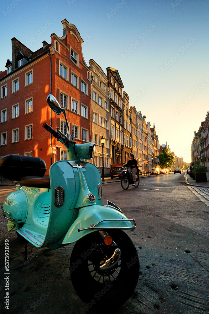 GDANSK, POLAND - CIRCA JUNE 2021: Electric scooter, in the background the historic facades of the historic buildings of the Main Town.