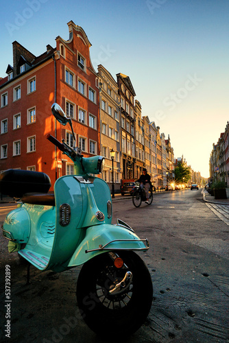 Obraz na płótnie GDANSK, POLAND - CIRCA JUNE 2021: Electric scooter, in the background the historic facades of the historic buildings of the Main Town. w salonie
