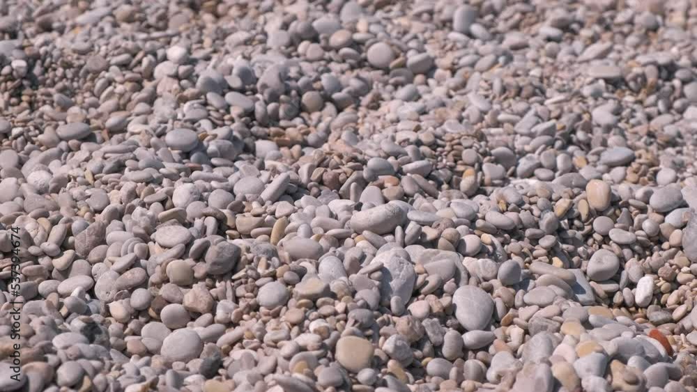 White pebbles on empty luxury beach. A view of white pebbles lay on the sea shore under the sun. A concept of summer traveling on luxury beach. White pebbles on empty luxury beach. A view of white pebbles lay on the sea shore under the sun. A concept of summer traveling on luxury beach.