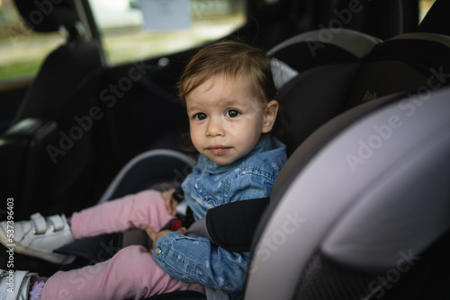 one small caucasian girl female toddler sit in the car safety seat