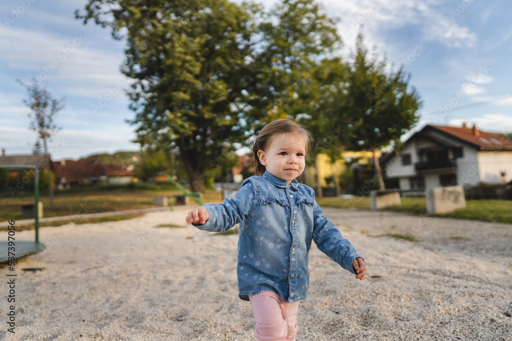 Portrait of one girl small caucasian female toddler child standing or walk alone outdoor in day childhood and growing up concept copy space Portrait of one girl small caucasian female toddler child standing or walk alone outdoor in day childhood and growing up concept copy space