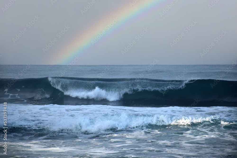 The waves crashing in the ocean, with a bluish tint at Drini Beach, Gunungkidul, Yogyakarta The waves crashing in the ocean, with a bluish tint at Drini Beach, Gunungkidul, Yogyakarta