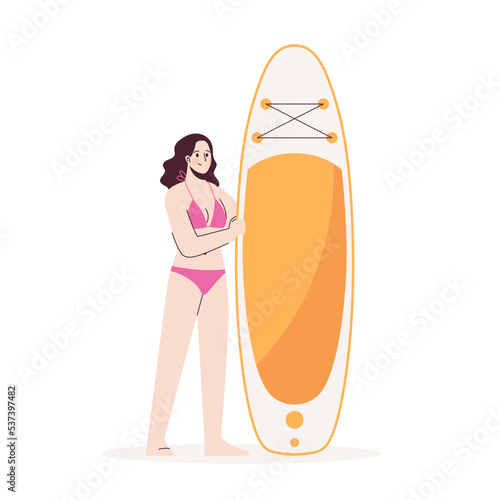 Young girl stands in swimsuit next to sup. Stand up paddle.