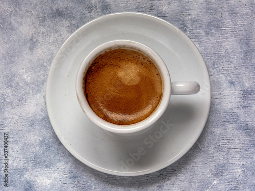 Cup of coffee on a white textured surface. © AlvaroRT