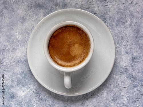 Cup of coffee on a white textured surface. © AlvaroRT