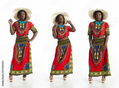 Full length 20s African American woman stand smile and happy confident. Young Adult female wear colorful African ethnic design dress express trendy stylish elegant, white background isolated