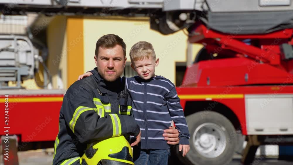 Portrait of firefighter with cute boy. Concept of saving lives, fire safety Portrait of firefighter with cute boy. Concept of saving lives, fire safety