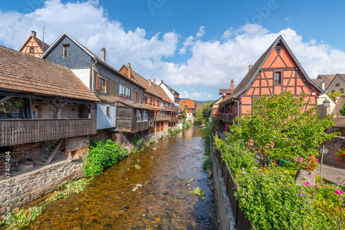 Half timbered medieval homes line the Weiss river canal in the historic town center of Kaysersberg, France in the Alsace region. Considered one of the most beautiful villages in France.