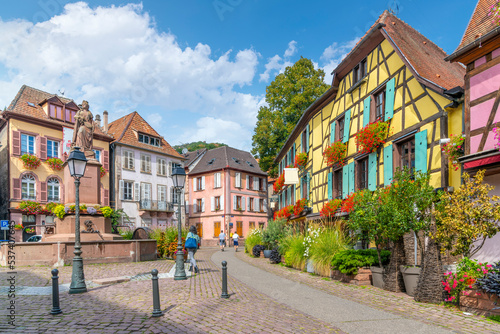 One of the many picturesque and colorful streets and alleys of half-timbered buildings in the medieval village of Ribeauville, France, in the Alsace wine region of France at Place de la Sinne Square. © Kirk Fisher