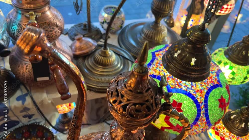 Turkish lamps have a multi-colored mosaic on them, they glow from the middle, shining and shimmering Nearby are Aladdin's lamps, various painted plates. The shop is lovely Showcase of vintage Turkish Turkish lamps have a multi-colored mosaic on them, they glow from the middle, shining and shimmering Nearby are Aladdin's lamps, various painted plates. The shop is lovely Showcase of vintage Turkish