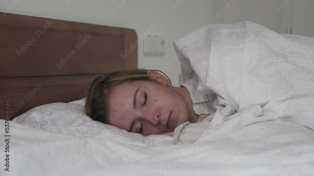 Sleeping caucasian brunette girl in bed, side slider view Sleeping caucasian brunette girl in bed, side slider view