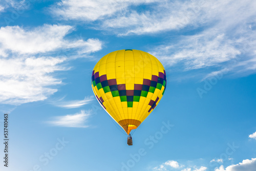 Colorful air balloon flying high up in the sky