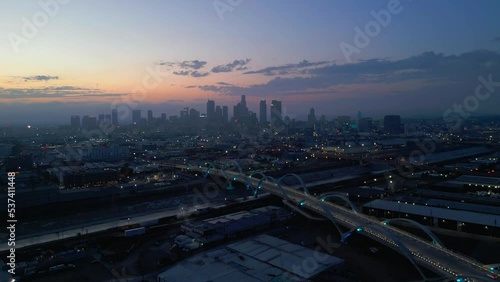 Aerial drone shot of 6th street bridge in Los Angeles, California at night.