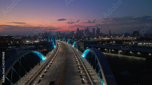 Aerial drone shot of 6th street bridge in Los Angeles, California at night.