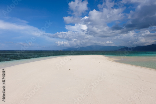 Remote uninhabited sandbar island with beautiful white sand surrounded by crystal clear ocean water in tropics of Bougainville, Papua New Guinea