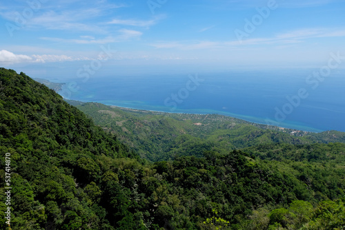 View of blue ocean and green tree covered hills and mountain landscape from Mount Manucoco on Atauro Island, Timor Leste, Southeast Asia photo