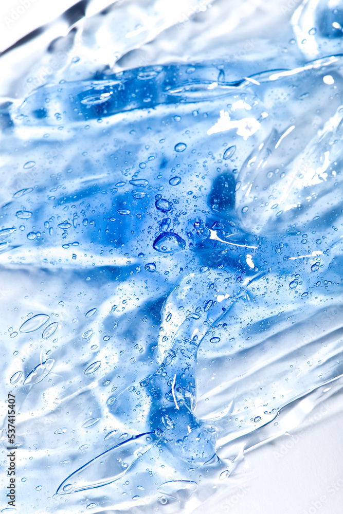 Gel texture of cosmetic serum. transparent cream for skin care on the background of bubbles. Transparent color cosmetic product close-up Gel texture of cosmetic serum. transparent cream for skin care on the background of bubbles. Transparent color cosmetic product close-up
