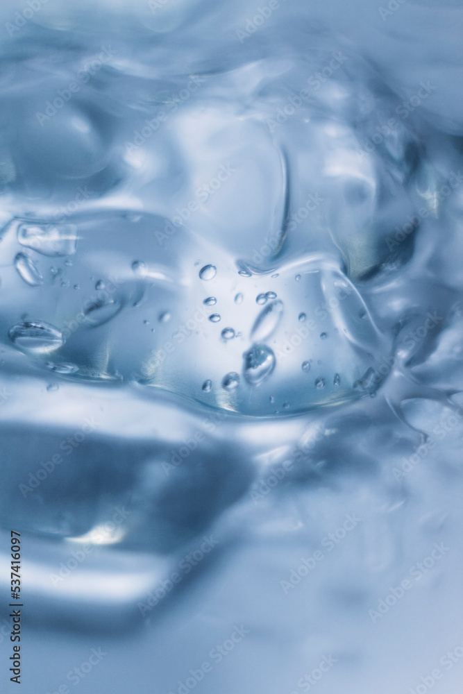 Gel texture of cosmetic serum. transparent cream for skin care on the background of bubbles. Transparent color cosmetic product close-up