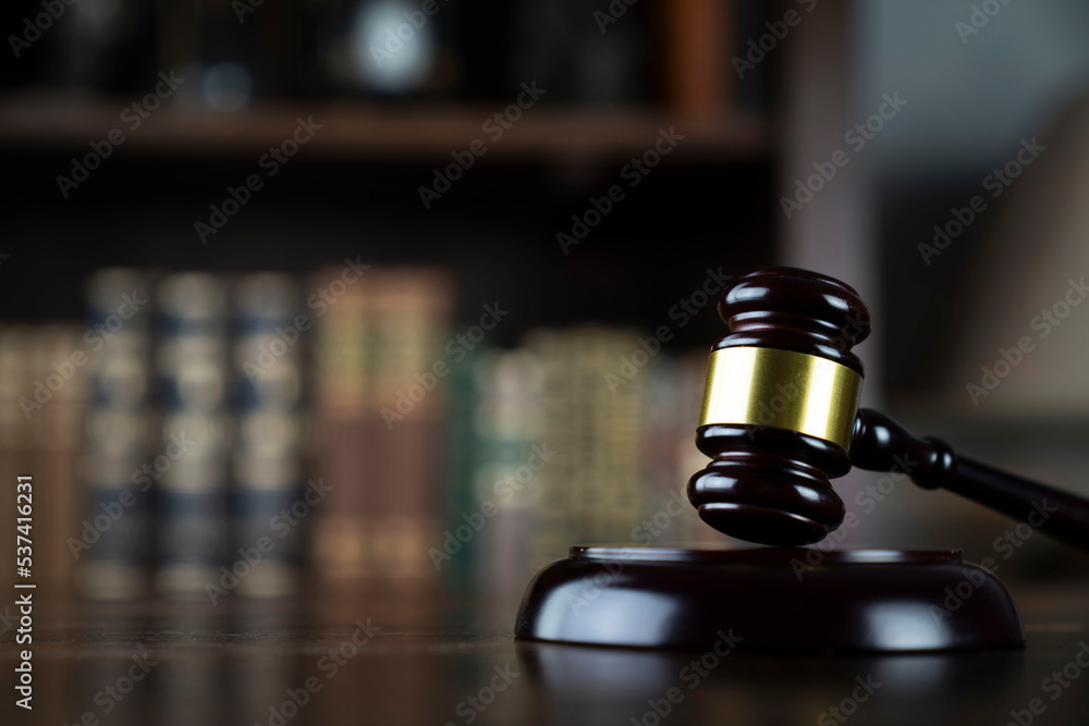 Lawyer office. Judge’s gavel and legal books in the bookshelf. Lawyer office. Judge’s gavel and legal books in the bookshelf.
