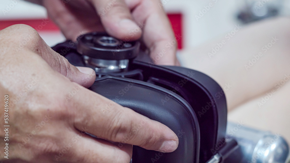 Man's hand holding the engine of an RC plane, he is repairing it. Man's hand holding the engine of an RC plane, he is repairing it.