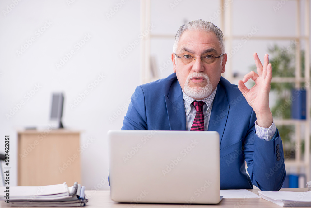 Old male employee and too much work in the office Old male employee and too much work in the office
