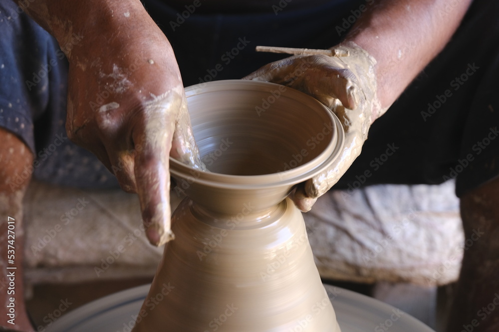 9 October 2022, Pune, India, Indian potter making Diya (oil lamps) or earthen lamps for Diwali Festival with clay, Handwork craft. 9 October 2022, Pune, India, Indian potter making Diya (oil lamps) or earthen lamps for Diwali Festival with clay, Handwork craft.