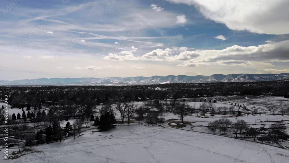 Rocky Mountains with Cloudy Skies on Beautiful Day • Snow Covered Park in Western Metro Denver • Slow Aerial Drone Shot • HD Horizontal Rocky Mountains with Cloudy Skies on Beautiful Day • Snow Covered Park in Western Metro Denver • Slow Aerial Drone Shot • HD Horizontal