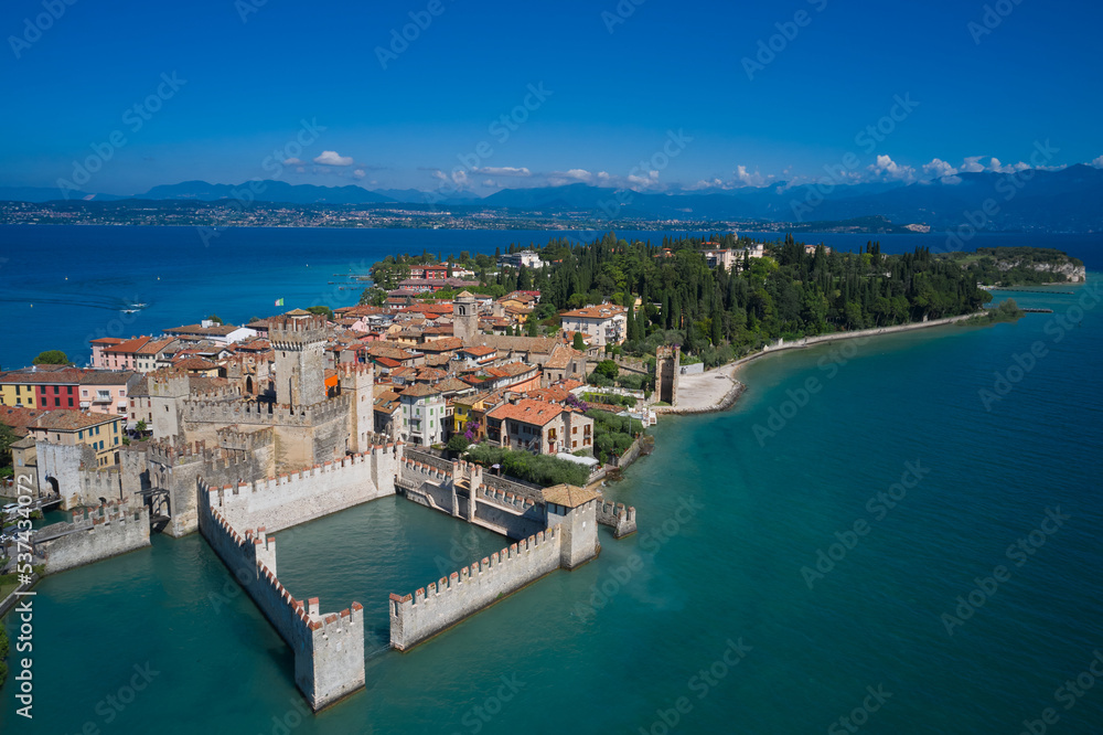 Tourist destination in Lombardy region of Italy.  Aerial view on Sirmione sul Garda. Italy, Lombardy. Rocca Scaligera Castle in Sirmione. Aerial photography with drone.