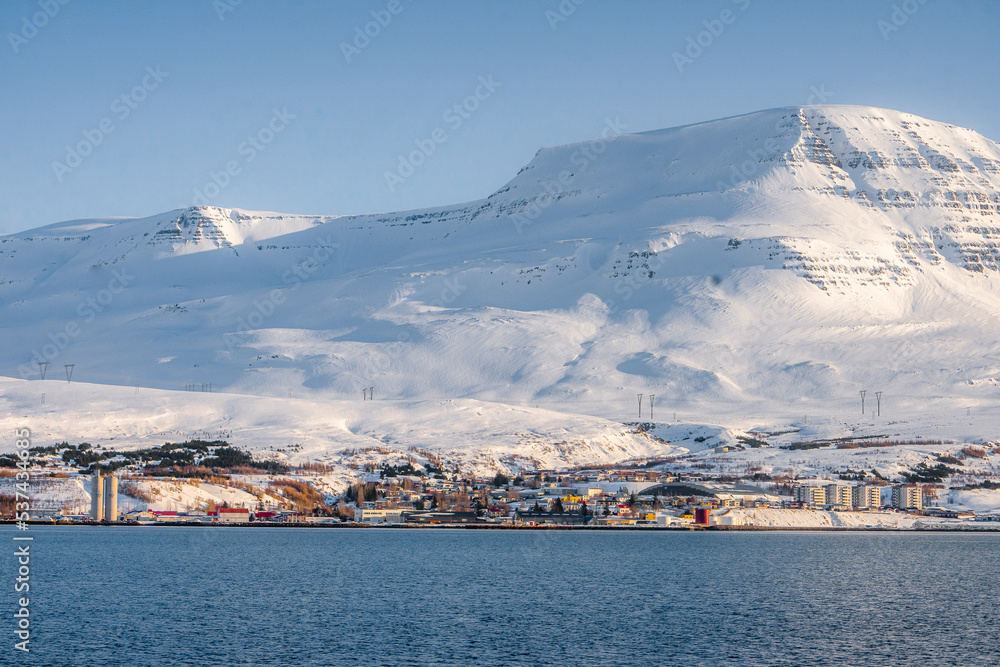 Along the way around Reydarfjordur , ports town close to the sea and snow mountain during winter sunny day at Reyðarfjörður , Fjord town on Eastern Coast of Iceland  : 19 March 2020