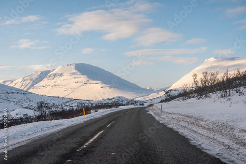 Along the way around Reydarfjordur , ports town close to the sea and snow mountain during winter sunny day at Reyðarfjörður , Fjord town on Eastern Coast of Iceland  : 19 March 2020 photo