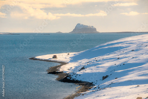 Along the way around Reydarfjordur , ports town close to the sea and snow mountain during winter sunny day at Reyðarfjörður , Fjord town on Eastern Coast of Iceland  : 19 March 2020 photo